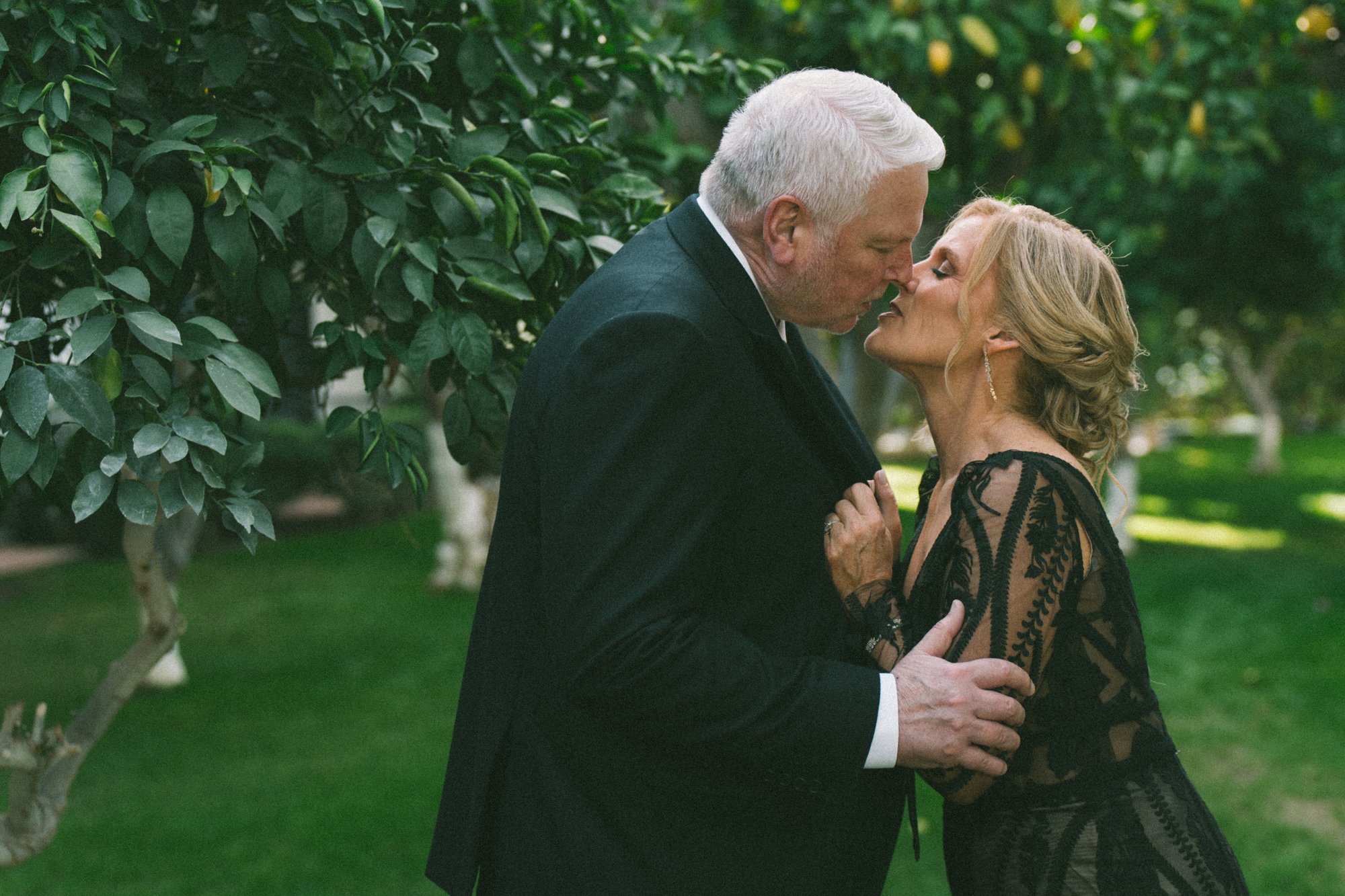Couple's kiss in a citrus garden — Coachella Valley wedding photography
